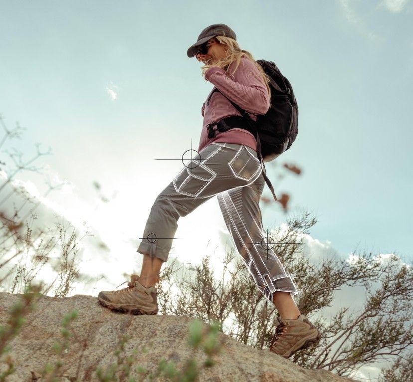 A woman hiking in the KUHL Splash Roll-Up Pant