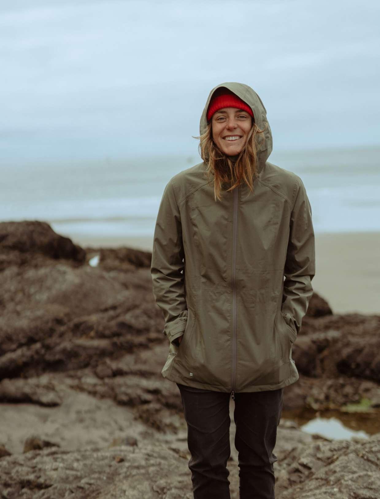 A girl in a KÜHL rain jacket on the beach