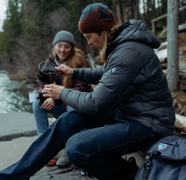 Man wearing crossfire hoody pouring coffee