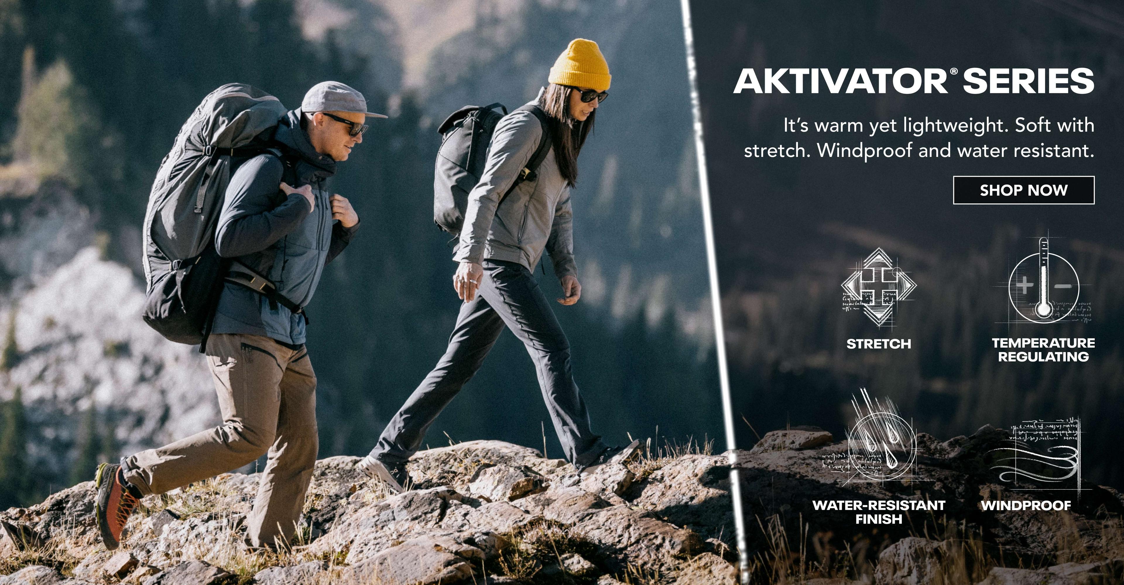 Man and woman wearing Aktivator jackets while on a hike.